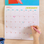 Close up of Cocktails 2026 calendar, showing the planner in use. Large monthly grid with week numbers, bank holidays, lunar phases, and recipe.