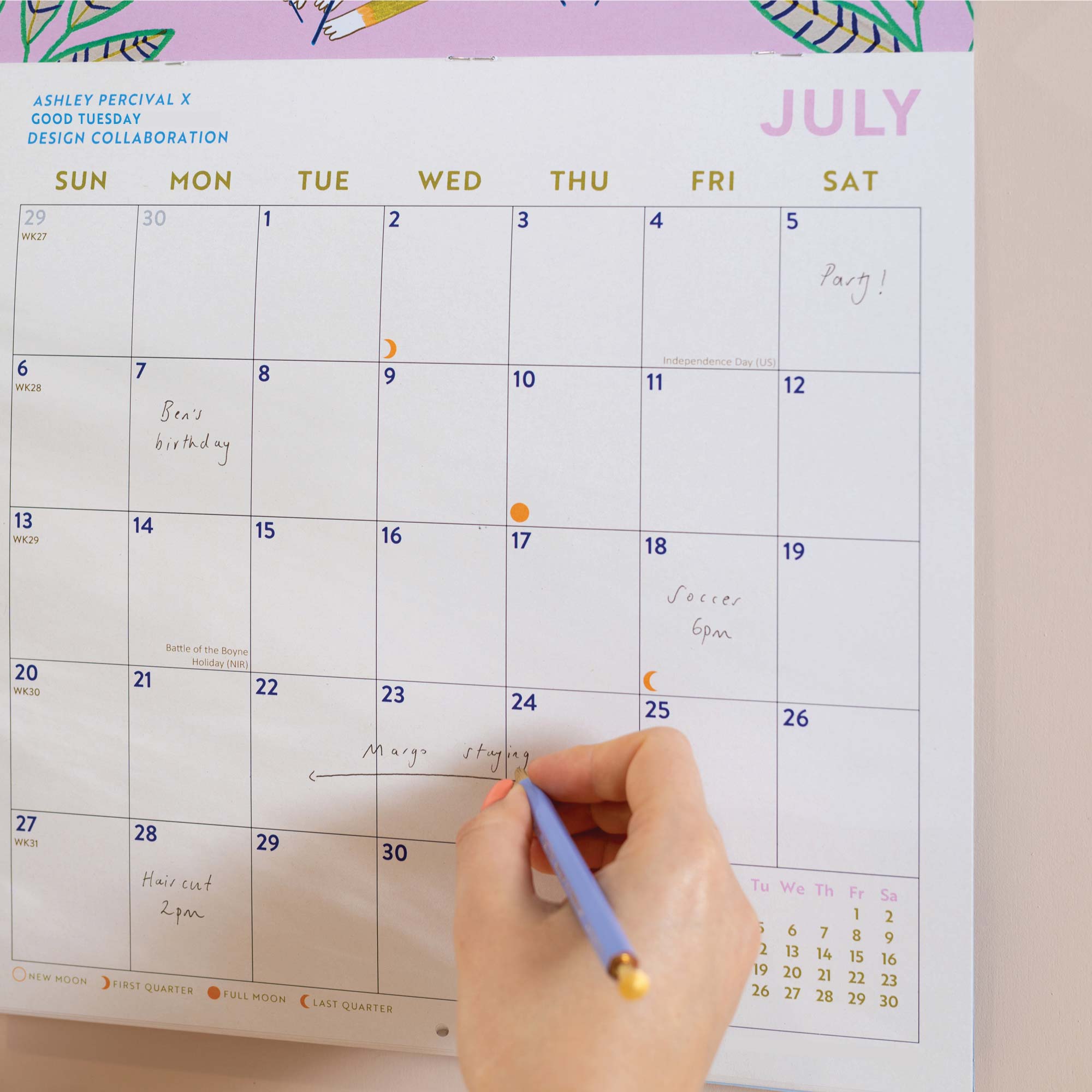 Close up of the Folk Animals 2026 calendar in use, showing the planner in use. Large monthly grid with week numbers, bank holidays, and lunar phases.