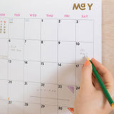 Close up of Modernist 2026 calendar, showing the planner in use. Large monthly grid with week numbers, bank holidays, and lunar phases.