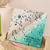 Front cover of 2026 large art calendar - ocean aerials design with illustrations throughout. Printed on 100% recycled paper.