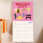 Close up of Destinations 2026 calendar, showing the planner in use. Large monthly grid with week numbers, bank holidays, and lunar phases.