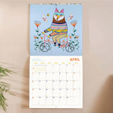 Month to view page of 2027 animal calendar with spacious date grid and playful fox riding a bike illustration