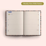 Open planner showing a weekly view with notes on a pink background. Recycled Paper.