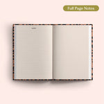 Open 2027 Diary with lined and dotted pages on a pink background.