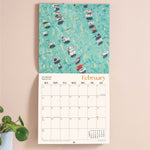 Wall calendar showing UK and US holidays notable dates week numbers and moon phases