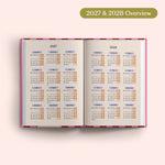 Open planner showing 2027 and 2028 yearly overview on a pink background.