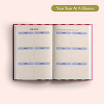Open planner with 2027 year-to-view on a pink background. B Corp. Year Planner.