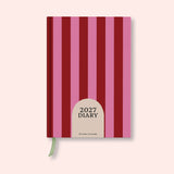 Pink and red stripe weekly 2027 diary with on a pink background. B Corp. Recycled paper.