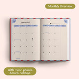 Open planner showing month-to-view January 2027 with moon phases and bank holidays on a pink background.