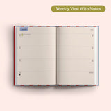 Open planner showing a weekly view with notes on a pink background. Recycled Paper.
