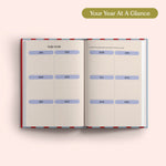 Open planner with 2027 year-to-view on a pink background. B Corp. Year Planner.