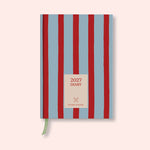 Blue and Red Striped weekly 2027 diary with on a pink background. B Corp. Recycled paper. With ribon. 