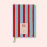 Blue and Red Striped weekly 2027 diary with on a pink background. B Corp. Recycled paper. With ribon. 