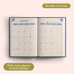 Open planner showing month-to-view January 2027 with moon phases and bank holidays on a pink background.