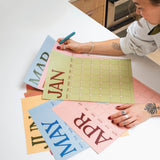 Boho scandi style undated A3 wall planner displayed on wall with muted colour palette