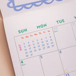 Month to view page of 2027 Dog Life calendar showing large date grid and dog artwork