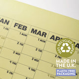 Close detail of 2027 Matcha Wall Planner by Good Tuesday, with badges showing 100% recycled paper, made in the UK, plastic free packaging.