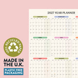2027 Pastel Monthly Grid Wall Planner on recycled paper with 'Made in the U.K.' and 'Plastic Free Packaging' text.