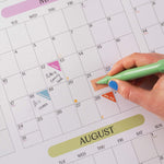 2027 A1 Pastel Monthly Grid Wall Planner in use with appointment and event stickers.