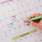 2027 A1 Pastel Monthly Grid Wall Planner in use with appointment and event stickers.