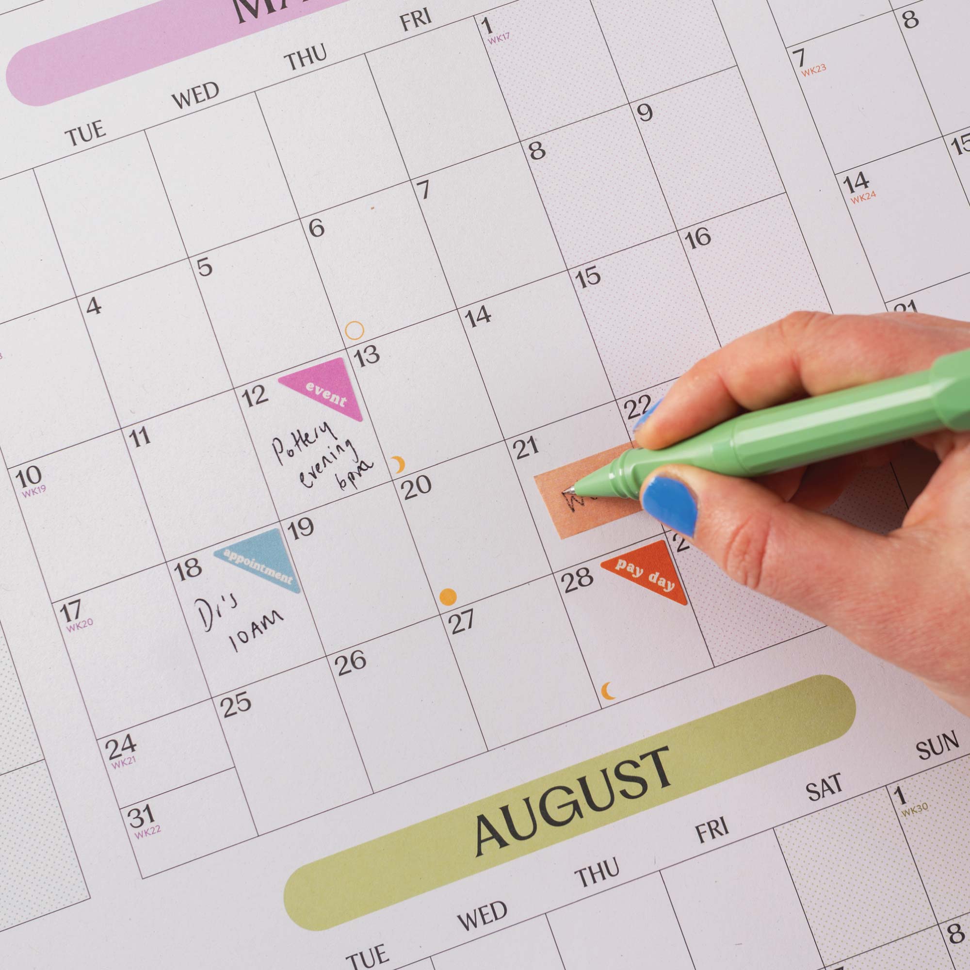 2027 A1 Pastel Monthly Grid Wall Planner in use with appointment and event stickers.