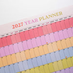 2027 Rainbow wall planner, week numbers and monthly grid layout