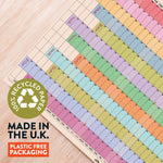 Colorful Wall planner with '100% Recycled Paper' label and text about UK manufacturing and plastic-free packaging.