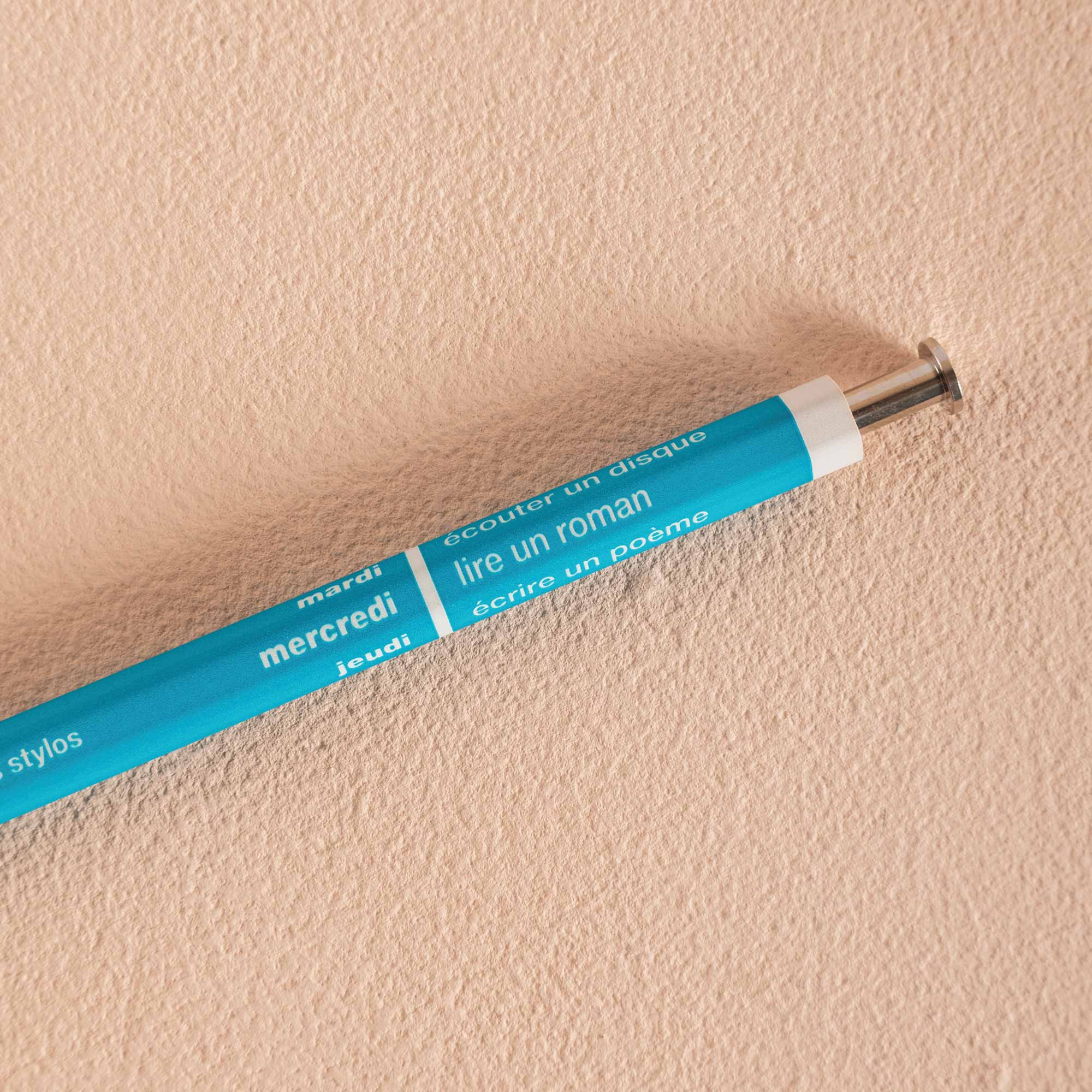 A vivid turquoise refillable ballpoint pen with a metal tip