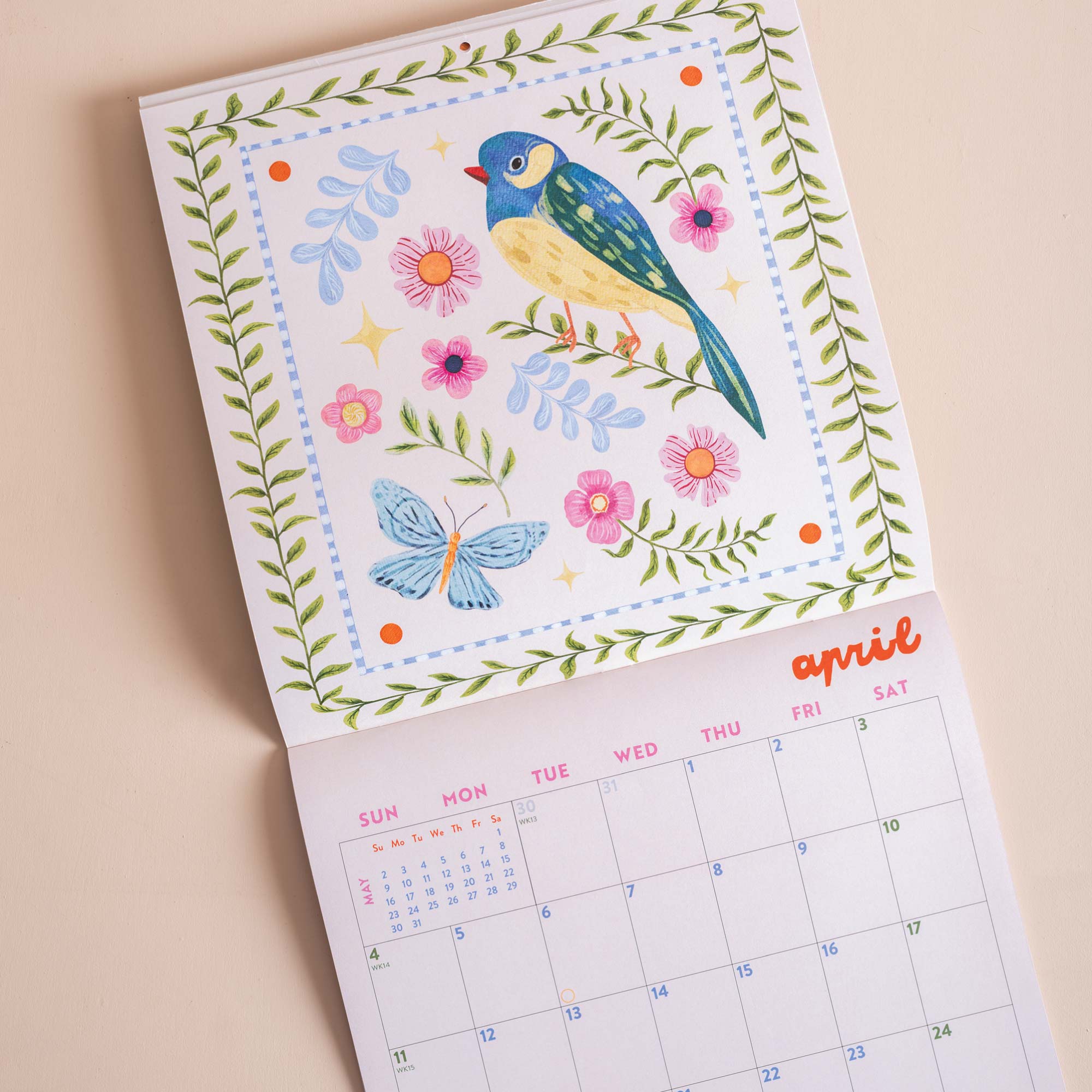 Close up of whimsical folk-style songbird artwork on 2027 wall calendar