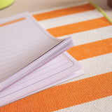 A4 tear away list pad with pages glued along top edge being flipped through