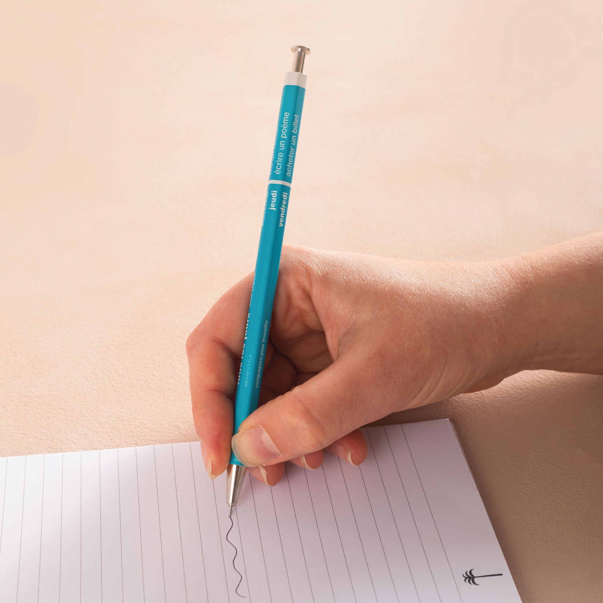 A vivid turquoise refillable ballpoint pen with a metal tip