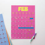 Pink calendar sheet with February dates on a white background