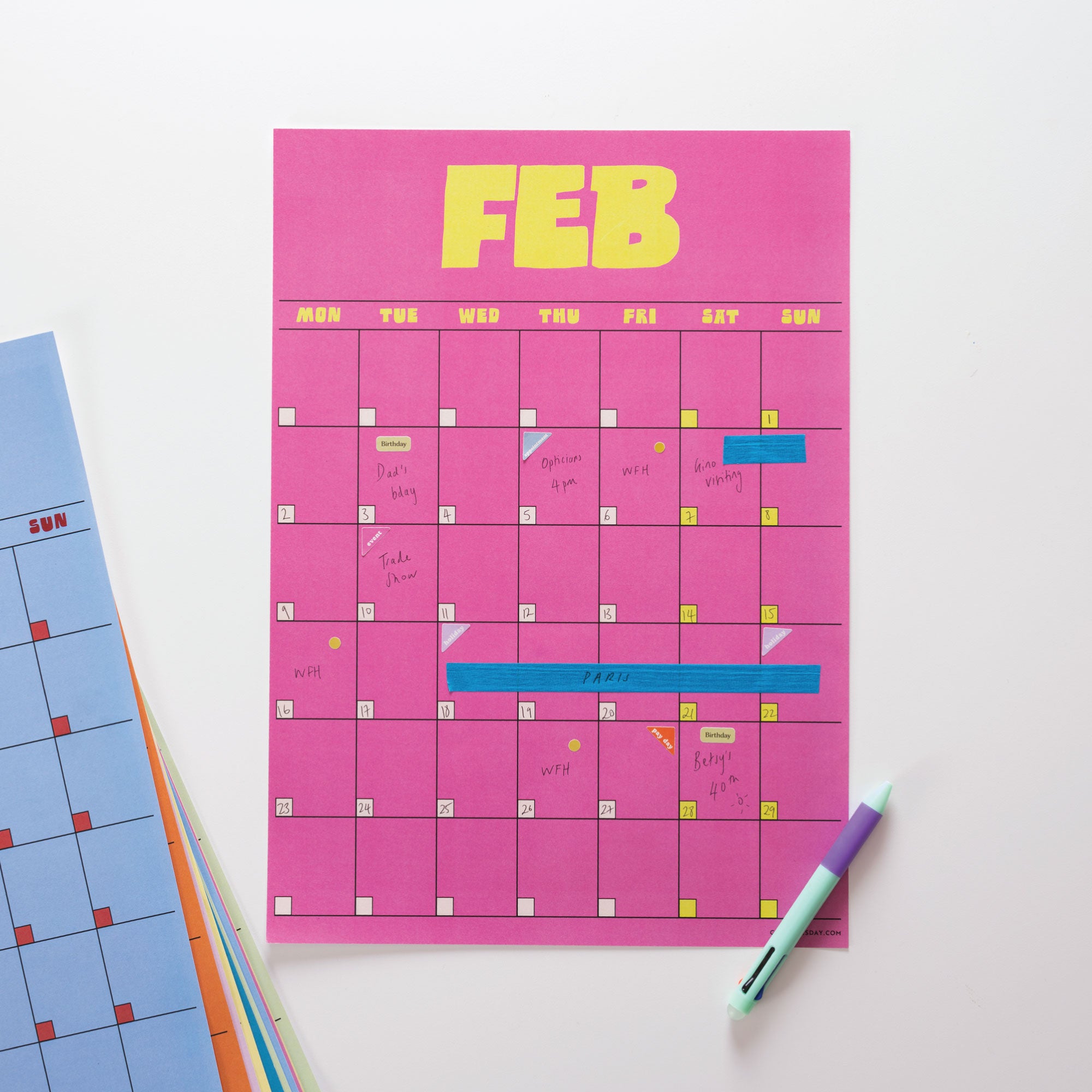 Pink calendar sheet with February dates on a white background