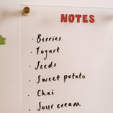 Acrylic wipeable notepad mounted on wall in use for weekly planning and notes