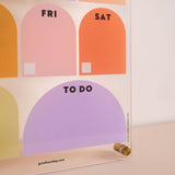 Wipeable weekly planner mounted on wall in use for organising weekly schedule