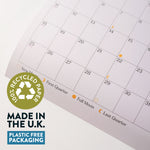 Calendar with recycled paper label and plastic-free packaging claim on a white background