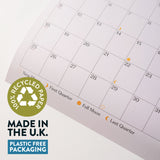 Calendar with recycled paper label and plastic-free packaging claim on a white background