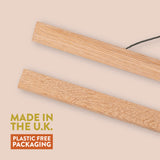 Two wooden strips on a beige background with 'Made in the U.K.' and 'Plastic Free Packaging' text.