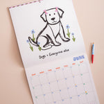 Close up of playful dog illustrations on 2027 Dog Life wall calendar