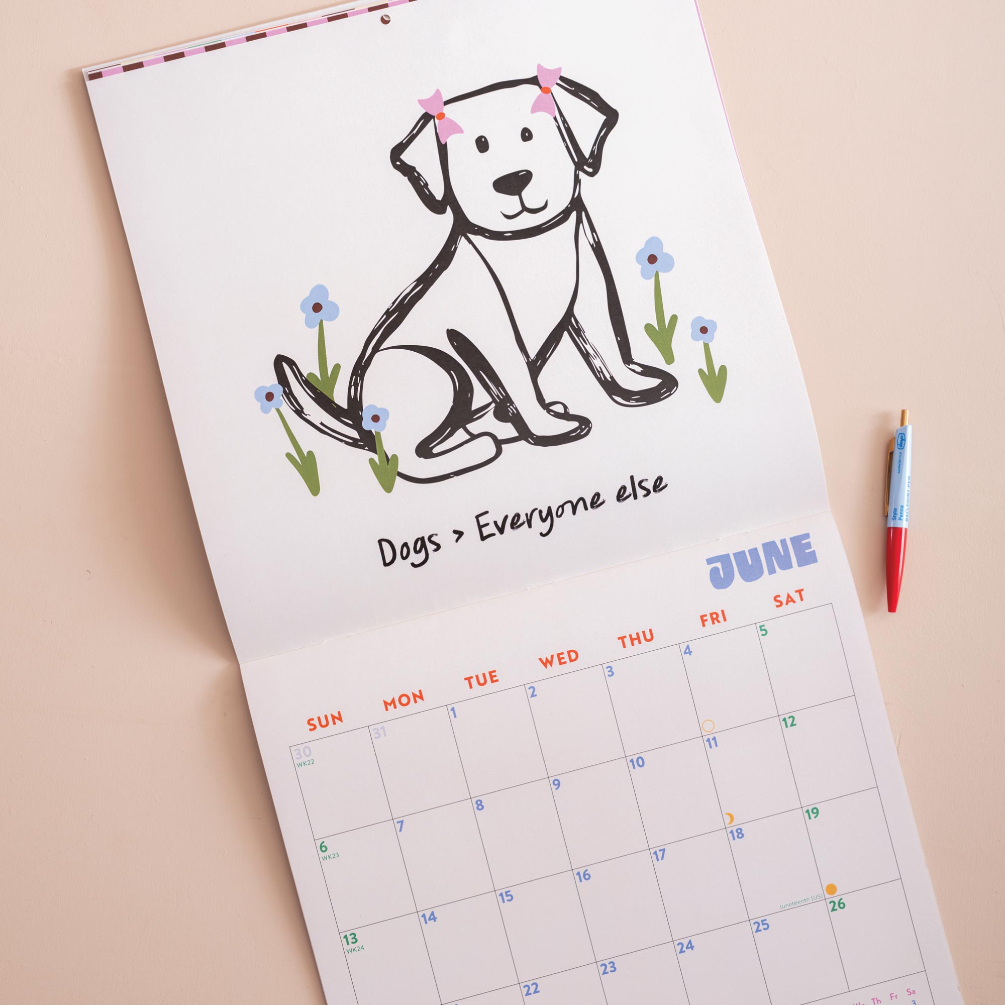 Close up of playful dog illustrations on 2027 Dog Life wall calendar