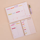 A4 Colour Theory Weekly Planner Pad shown on a desk alongside stationery