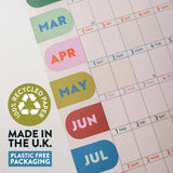 Calendar with colorful month labels and a recycling logo on recycled paper, made in the U.K.