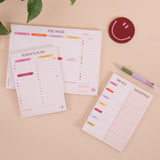 A5 Colour Theory Daily Planner Pad shown on a desk alongside stationery