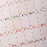 Calendar with dates highlighted in different colors on a light gray background