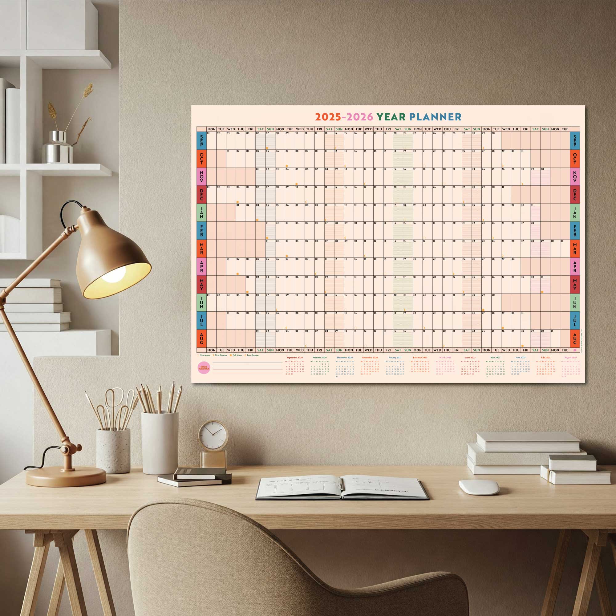 Playful and colourful A1 wall planner shown hanging above a desk