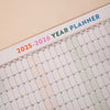 close up of academic wall planner showing highlighted weekends and moon phases