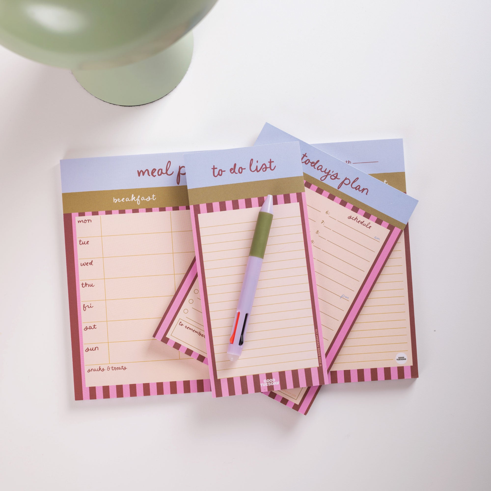 Set of three notepads with different uses on a white surface