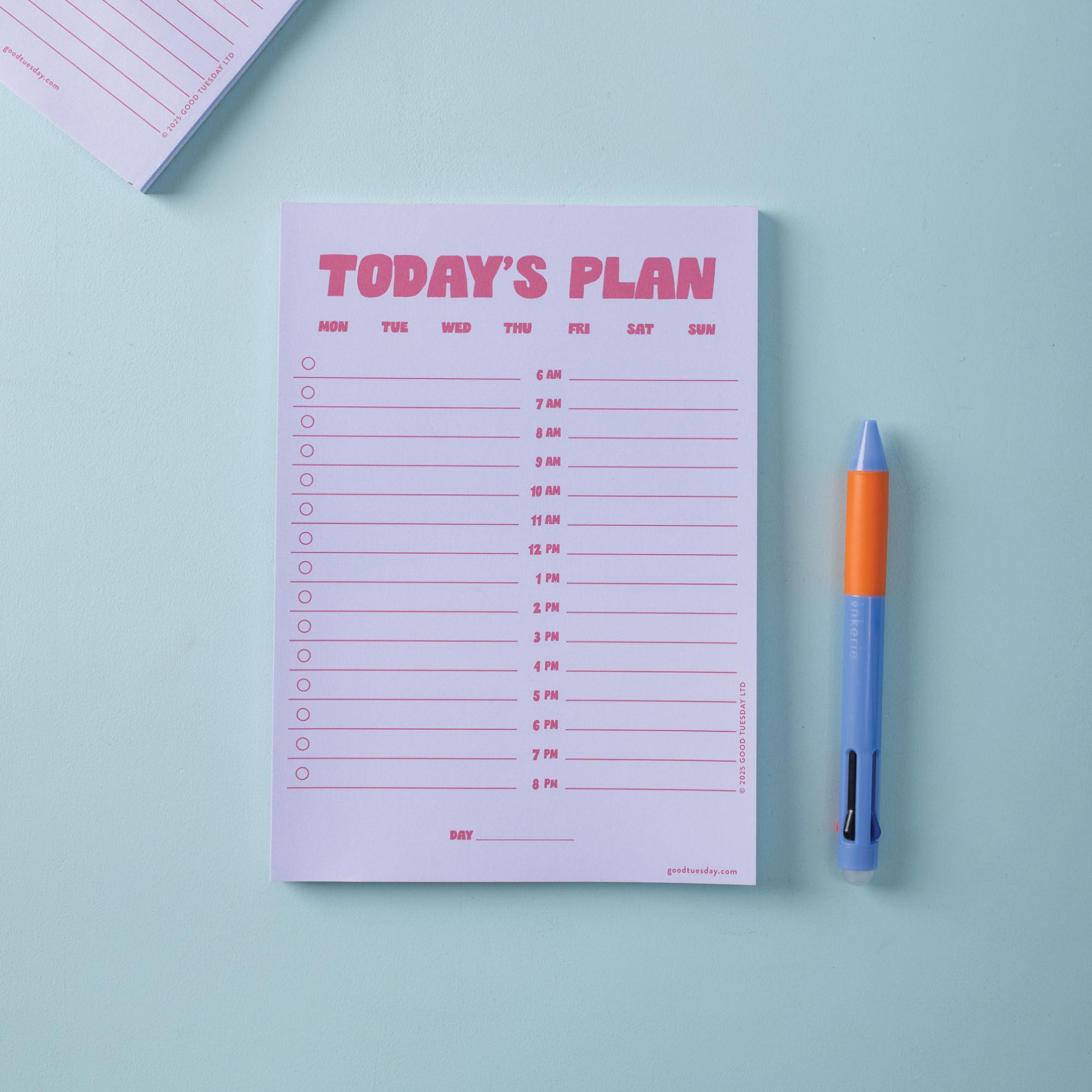 Lilac and Plum Notepad with 'Today's Plan' schedule and a pen on a light blue background
