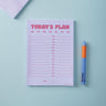 Lilac and Plum Notepad with 'Today's Plan' schedule and a pen on a light blue background