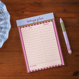 Notepad with 'today's plan' on a wooden surface with a pen next to it
